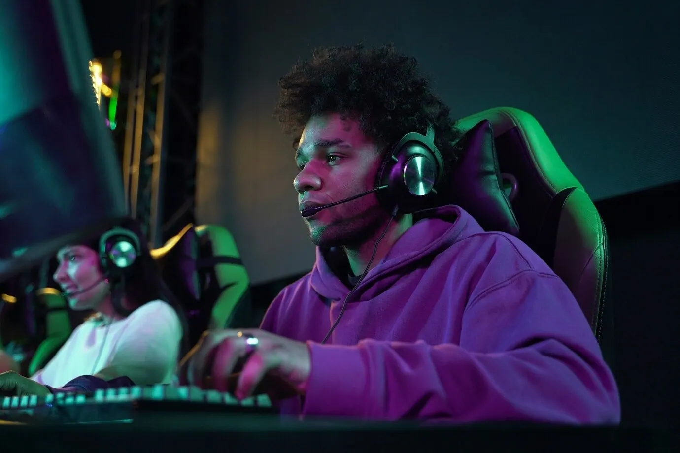 Young man wearing a headset while playing a video game