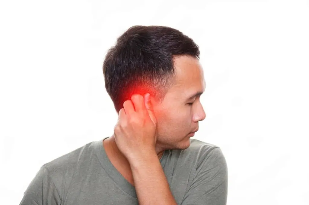 Man holding his ear and neck with the painful area highlighted