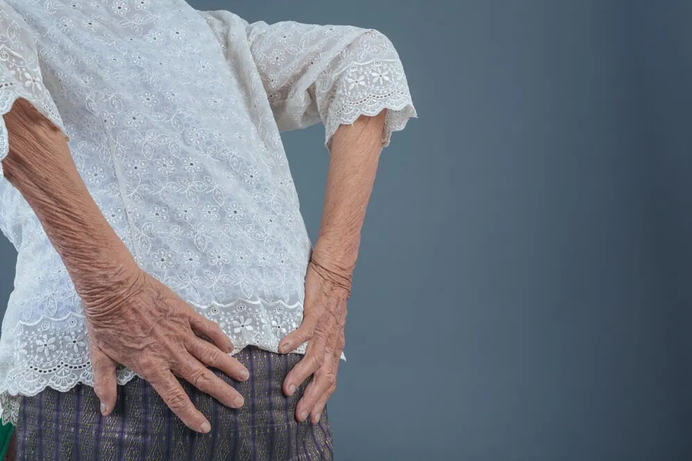 Older woman holding her lower back