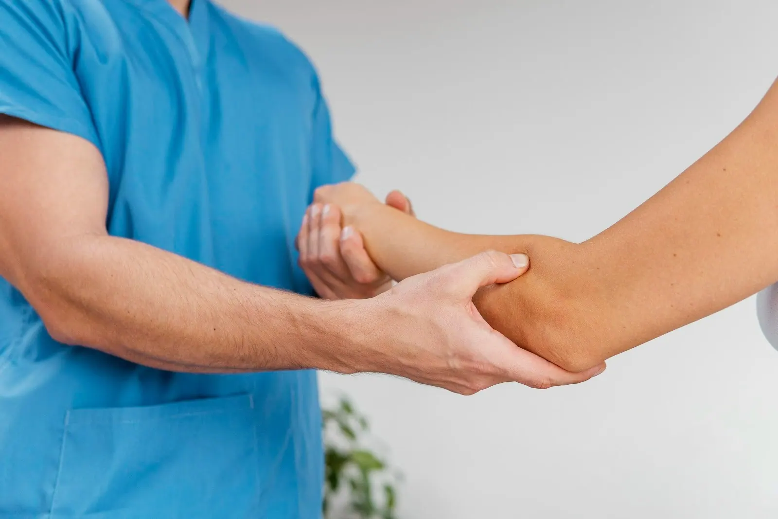 Practitioner holding a patient's forearm