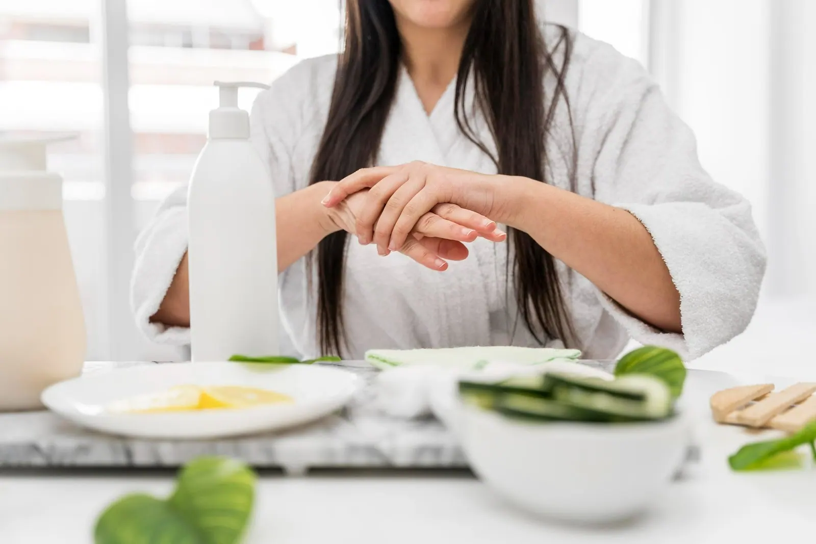 Woman at a table holding her wrist