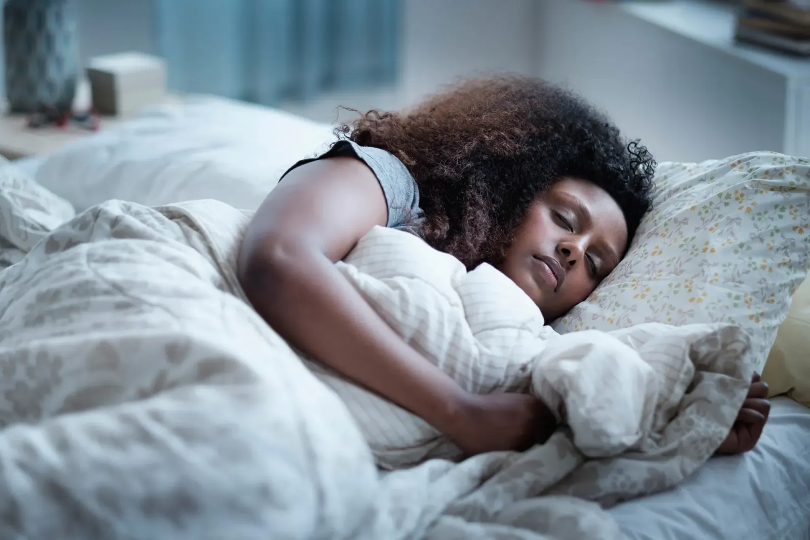 Woman sleeping on her side in bed