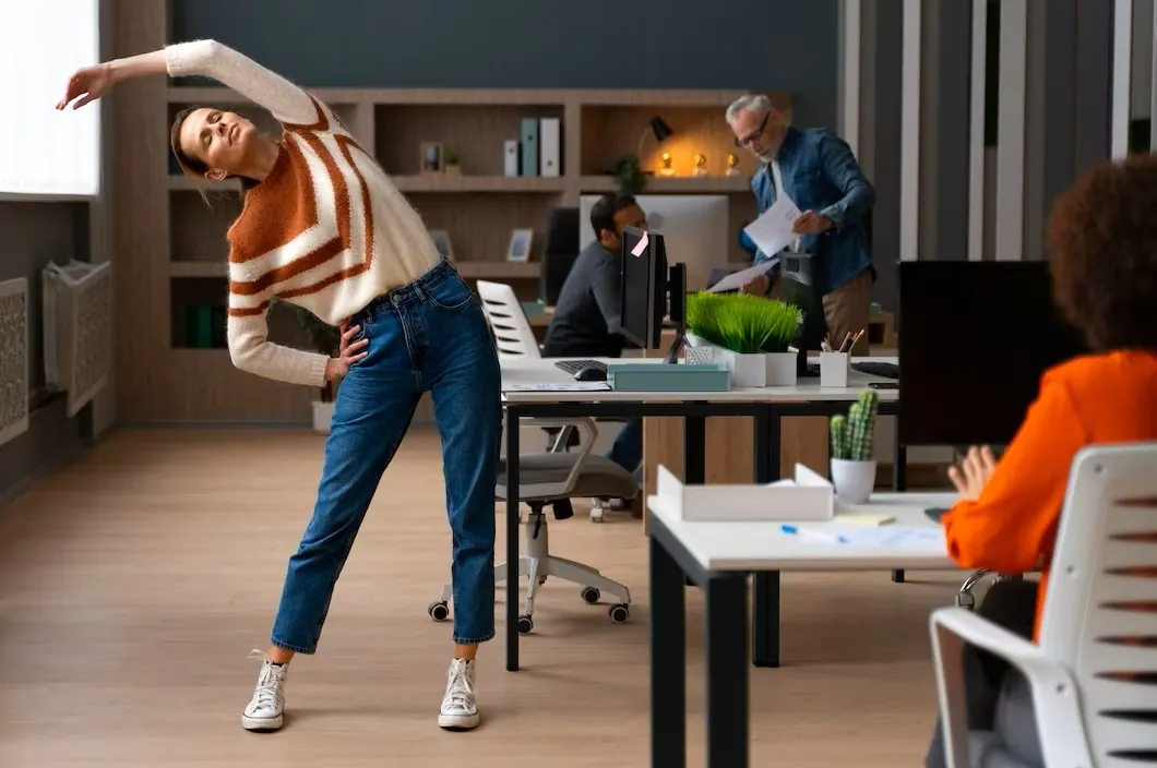 Woman doing a side stretch in an office