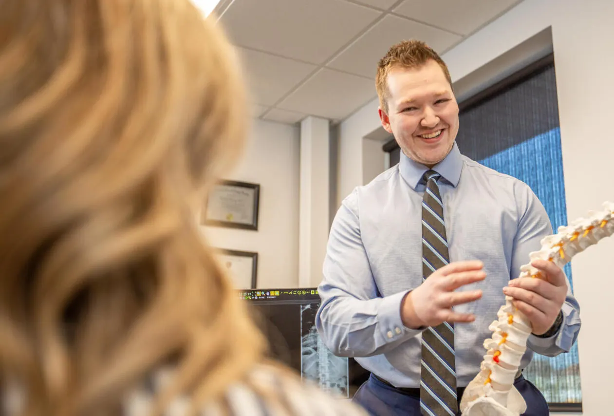 Dr. Nicholas Barney holding a spine model