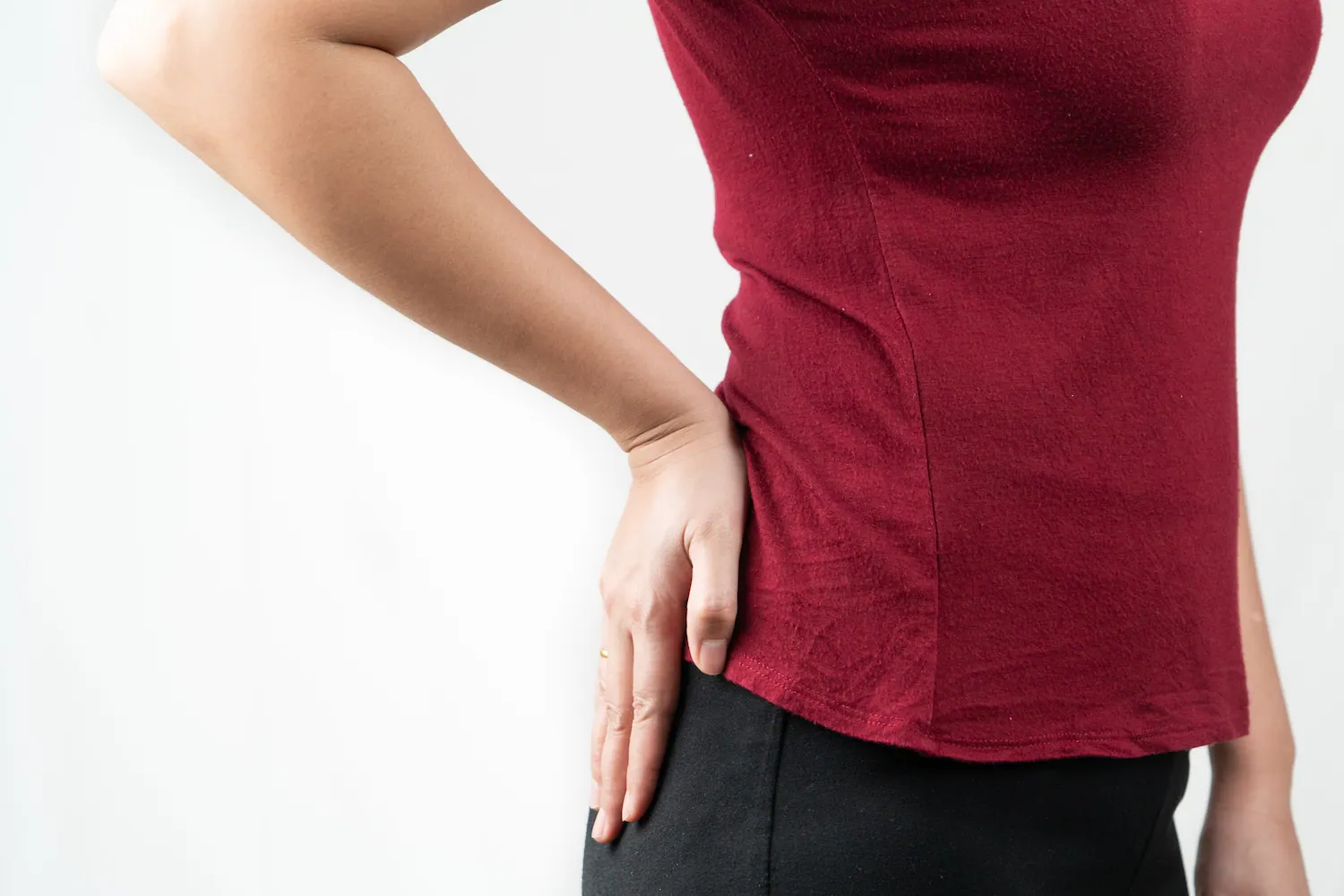 Woman holding her side and hip