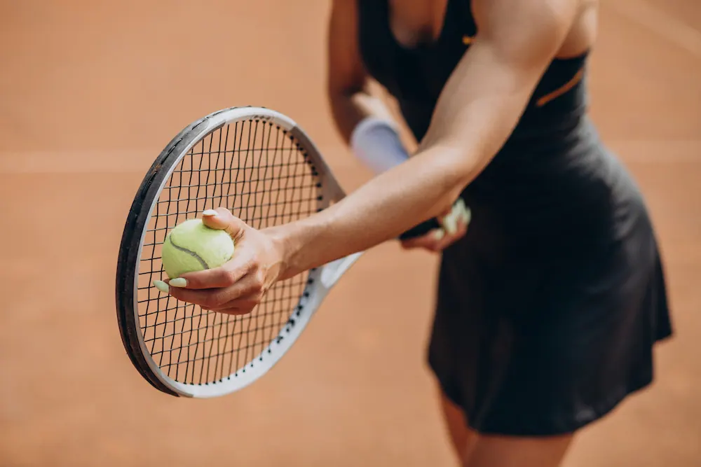 Woman preparing to serve a tennis ball