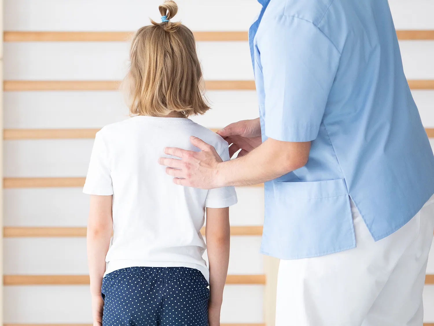 medical practitioner checking on kids scoliosis treatment