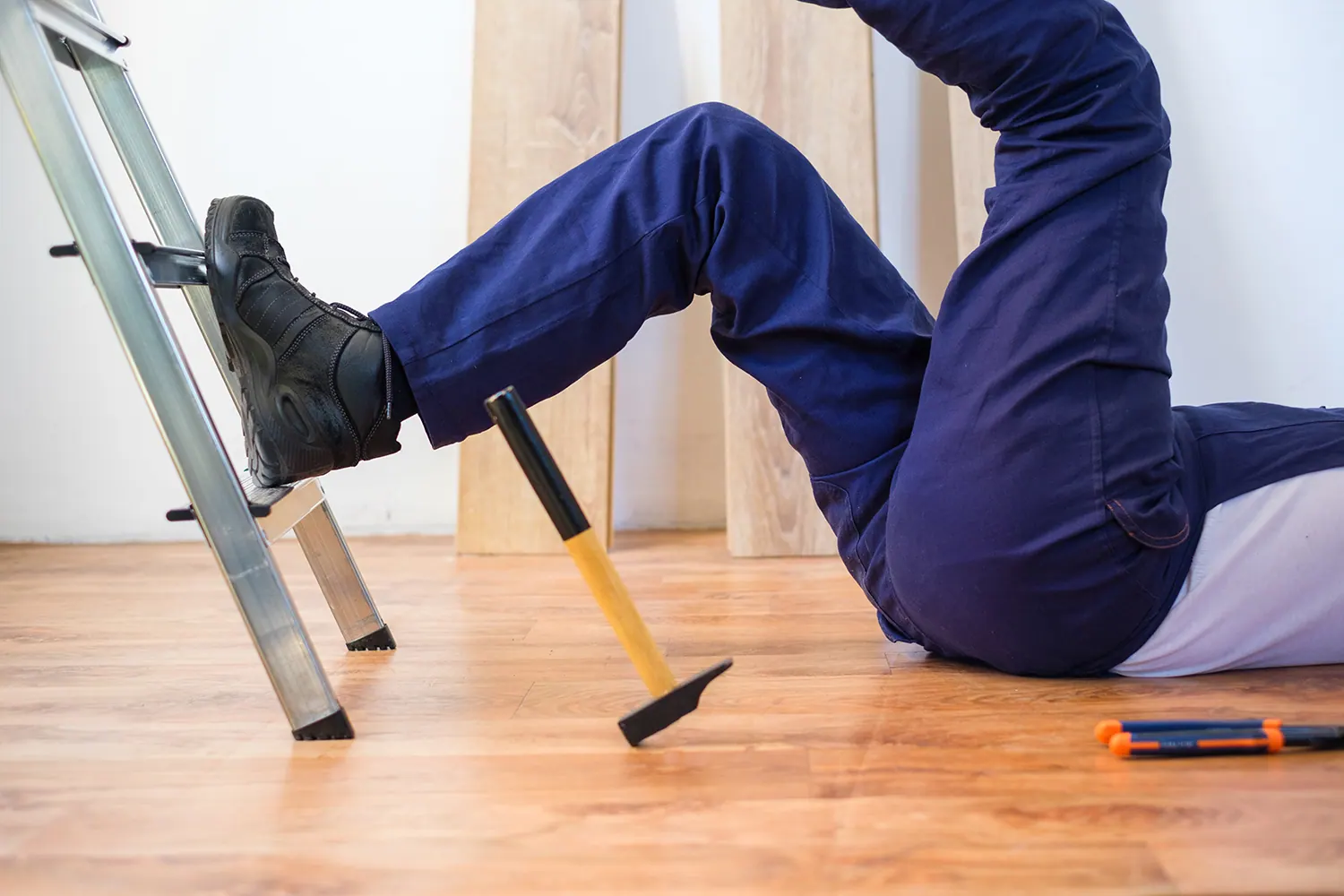 Man falling backward off a ladder onto the floor